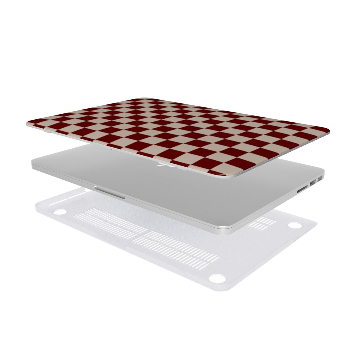 Laptop with a red and white checkered cover on a white background