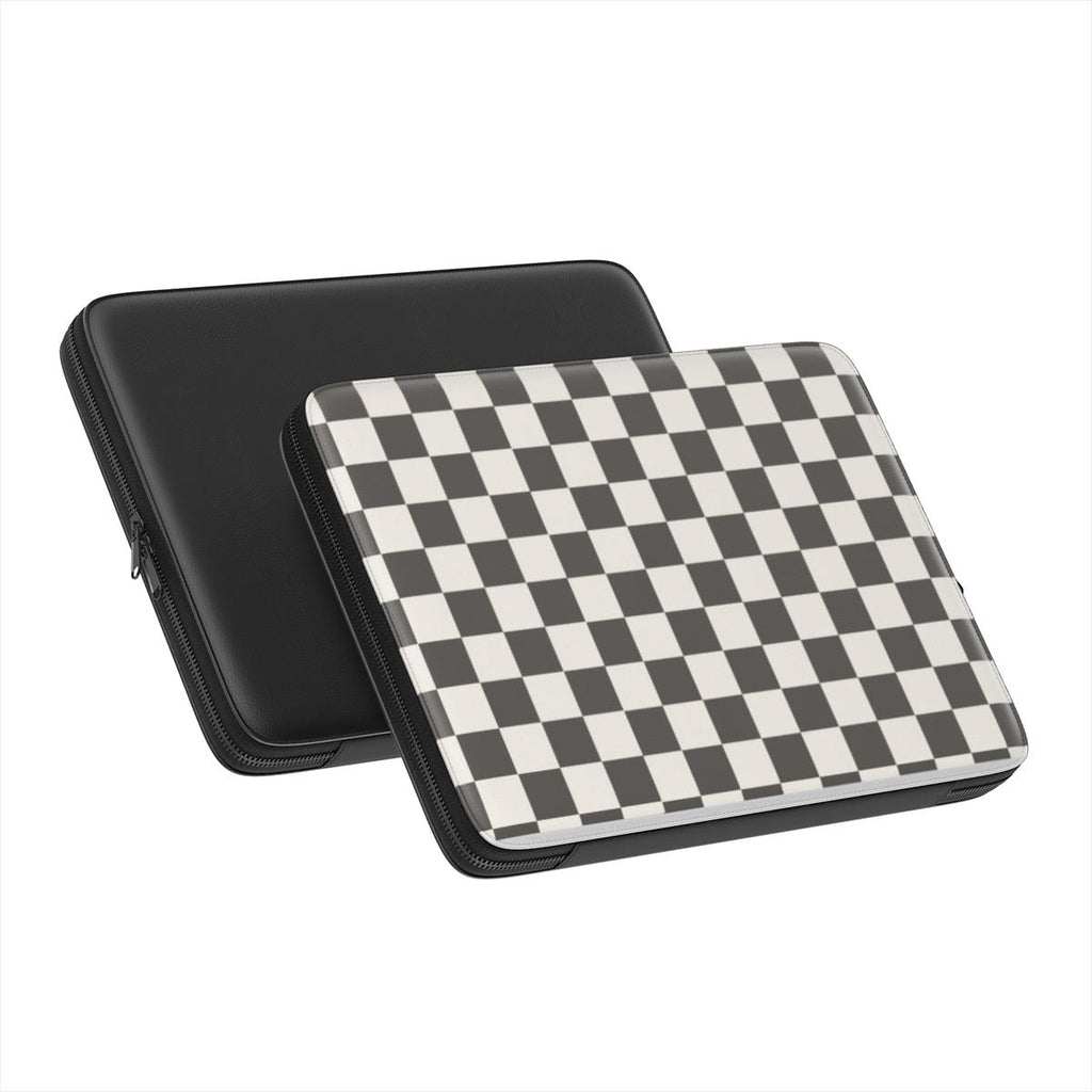 Black and white checkboard pattern laptop sleeve with a plain black sleeve on a white background