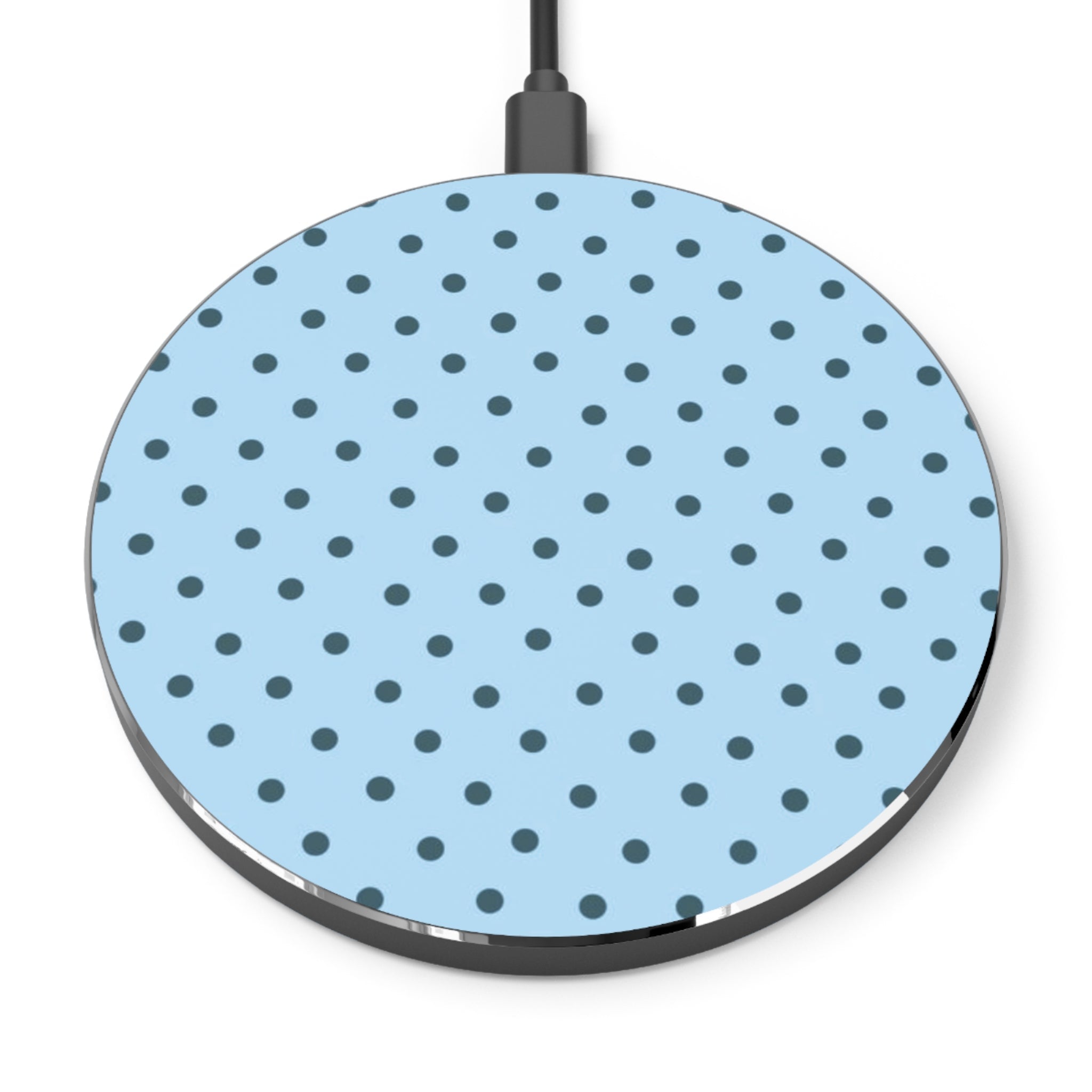 Round wireless charging pad with blue polka dot pattern on a white background
