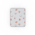 Apple iPad with a light pastel blue and peach floral patterned cover on a light gray background