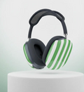 Black airpod max headphones  with  green  and white striped headphones on a white pedestal with a light gray background