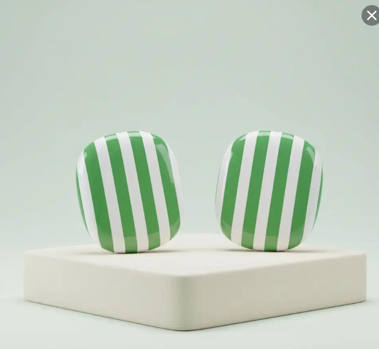 Green and white striped airpod max covers  on a light green background. 