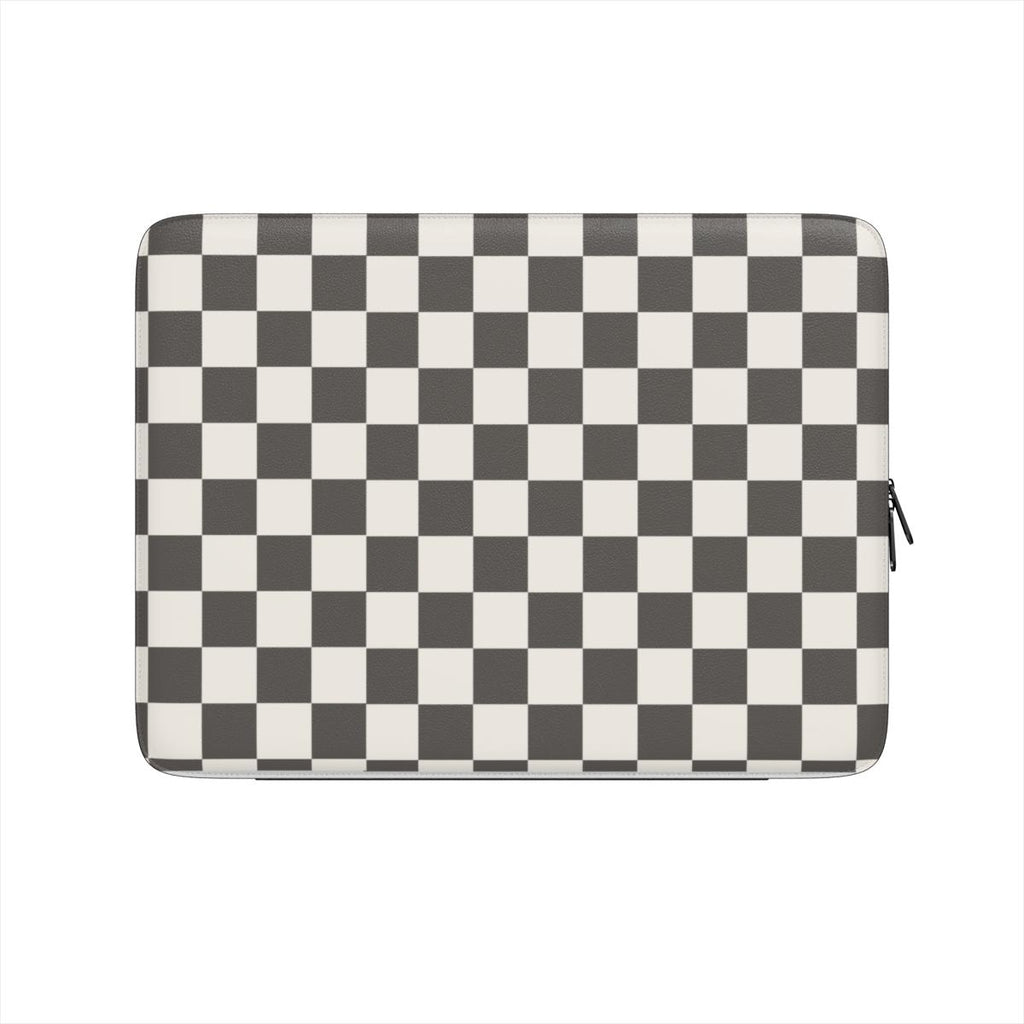 A  black and white checkered design on a luxurious vegan laptop sleeve on a light gray background
