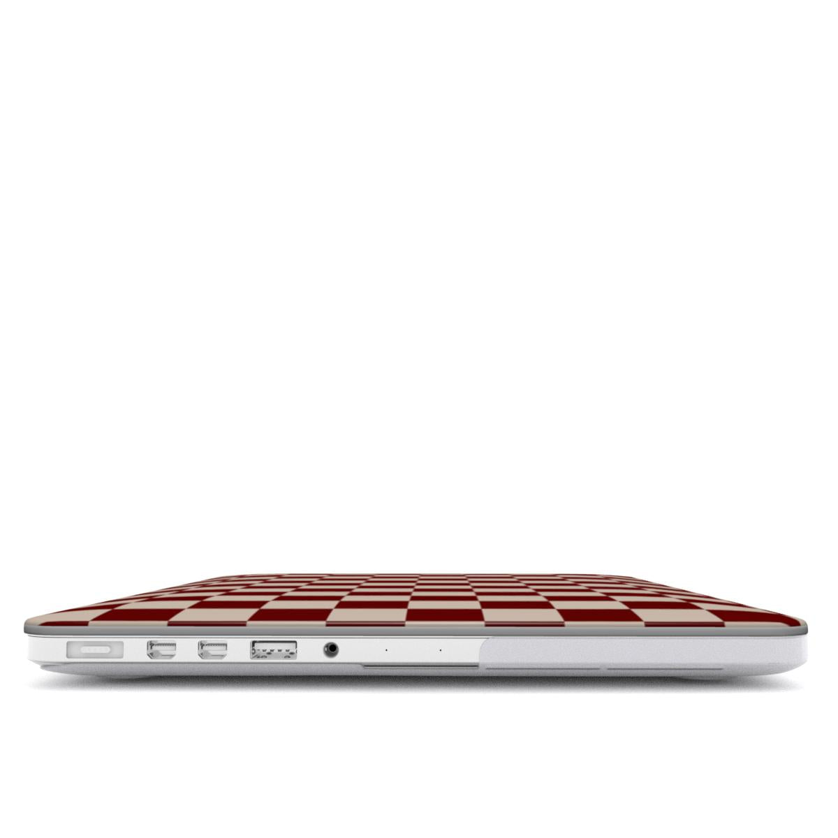 Laptop with a burgundy and white checkered design on a white background showing open ports from side.